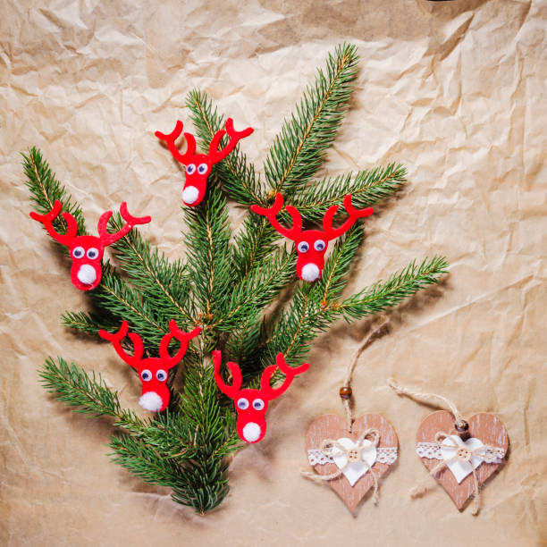 christmas decoration, spruce twigs decorated on grey paper, flat lay