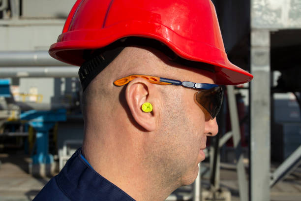 Construction Worker Wearing Protective Ear Plugs Construction Worker Wearing Protective Ear Plugs ear plug stock pictures, royalty-free photos & images