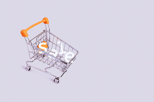 Banner with shopping cart and word sale. Grocery shopping and sale concept. Black friday, online shopping concept. Sale discount. Background with copyspace. Creative design. Stock photography.