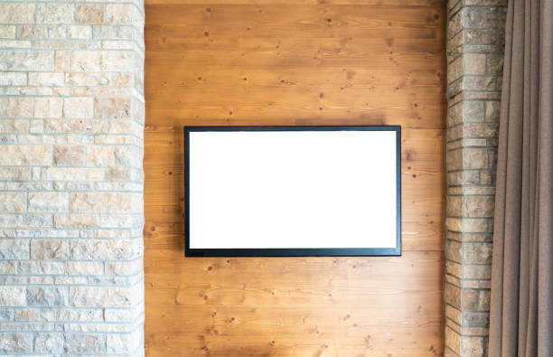 istock Blank modern flat screen TV at the brick and wooden wall with copy space 1192930605