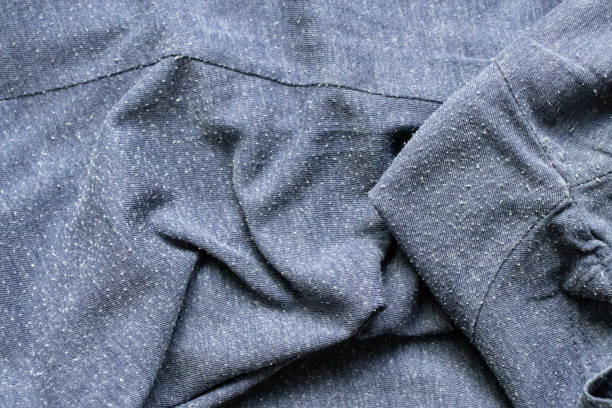 Pills on the heather blue tee-shirt cotton knit fabric. Bobbles on the knitwear.