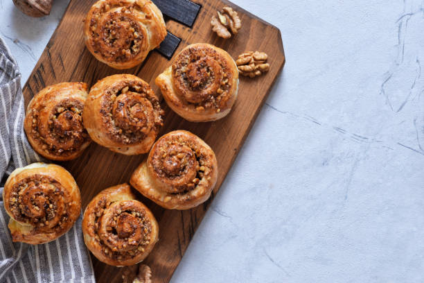 istock Snail buns with cinnamon and nuts on a concrete background. 1192931902