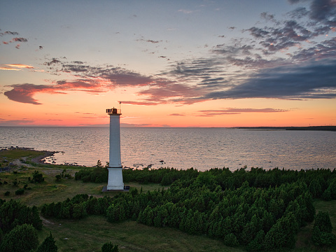Lighthouse by the Baltic sea, in Estonia, As daylight begins yielding to twiligh, beautiful sunset light, drone photography