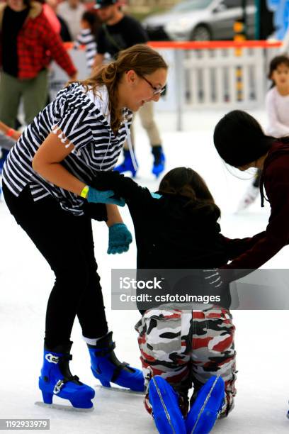 People Enjoying The Outdoor Ice Skating Rink In Downtown Tucson Az Stock Photo - Download Image Now