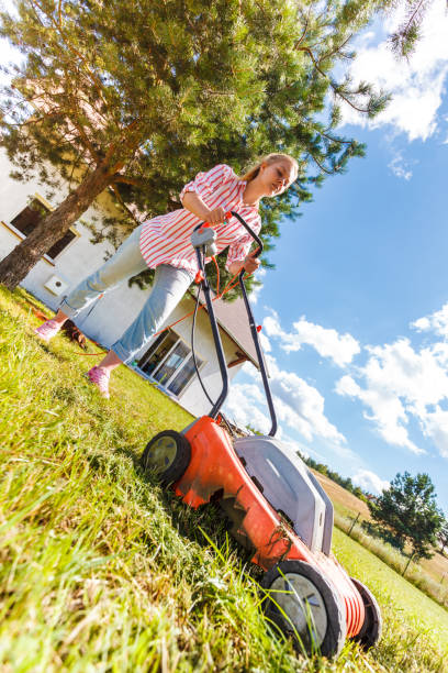 istock Woman mowing green grass 1192941005