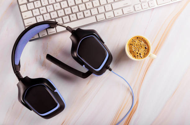 istock Headphone on the table by the keyboard in the call center and technical support service on cup of coffee 1192941186