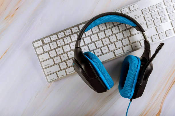 istock Office desk with headset and pc keyboard call center support table. Veiw with copy space 1192941188