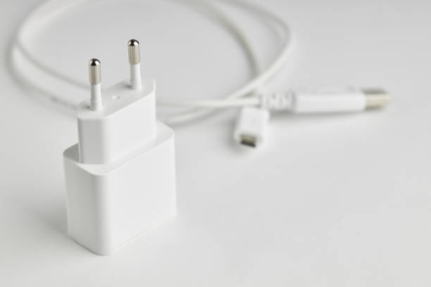 white usb charge or power adapter with usb wire at background. charging portable information devices.