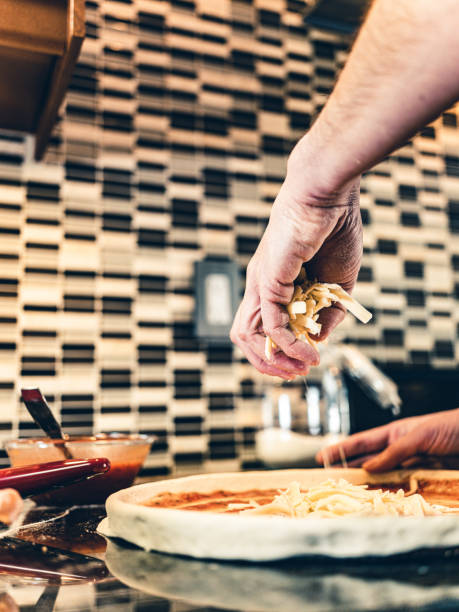 istock Hands of Man making pizza 1192943438
