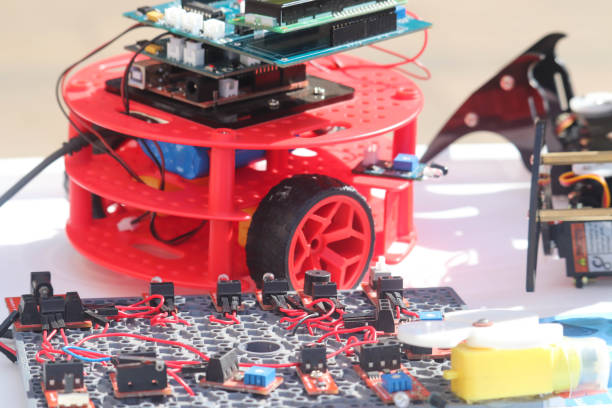 istock Red Educational Robots Usings Electronic Boards Wires and Plastic Parts Hand Made Robotics Technology 1192944396
