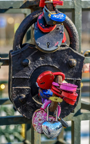 istock Lovers close the lock on the bridge post, and the key is thrown into the river. 1192946239