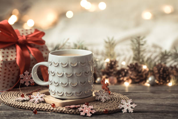 istock Festive background with Cup on wooden background with lights. 1192946501