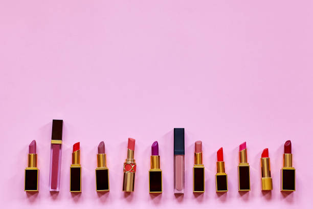 istock Many colorful opened lipsticks, setting in a raw on bright pink background 1192947295