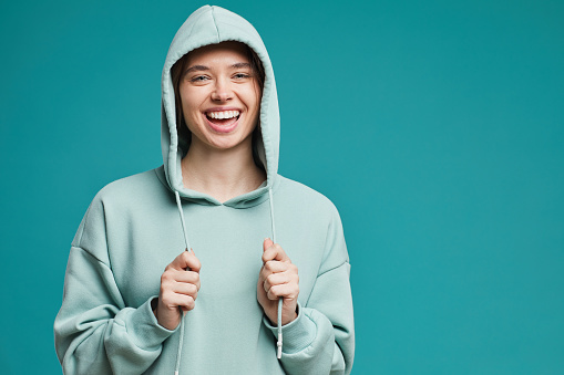 Portrait of happy girl in teal hoodie