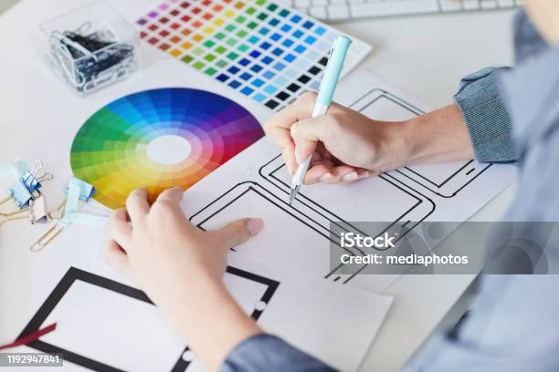 Closeup Of Unrecognizable Designer Sitting At Desk With Papers And Drawing Interface Design For Digital Devices Stock Photo - Download Image Now