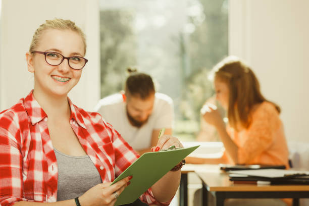 istock Student girl in front of her mates in classroom 1192948954