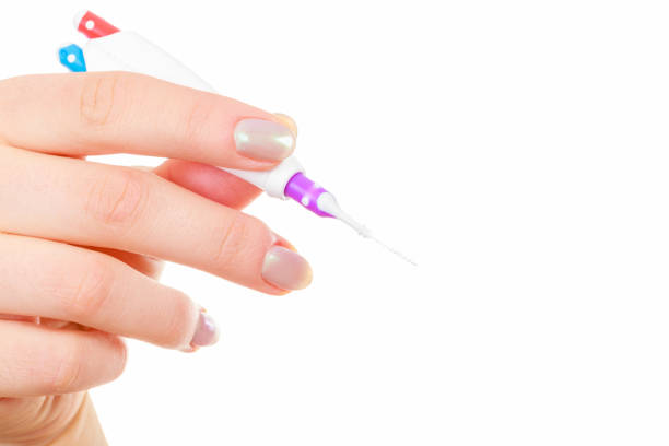 istock Woman holding toothbrush special for braces 1192949340