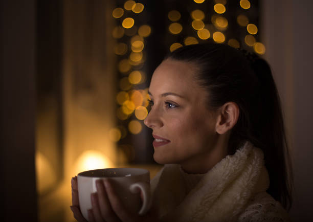 istock Girl drinking coffee in christmas ambient 1192950763