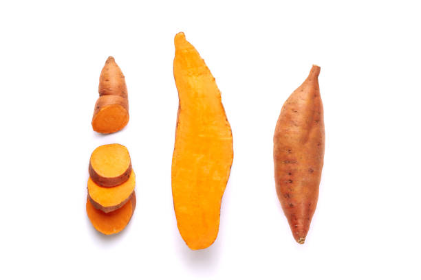 Sweet Potato Root Tuber, Peeled and Sliced Pieces Beauregard Sweet Potato Root Tuber, Peeled and Sliced Pieces Clipping Path. Vitamin Uncooked Orange Batata Isolated on White Background. Farmland Product Appreciated to Make Cakes or to Eat Roasted sweet potato photos stock pictures, royalty-free photos & images