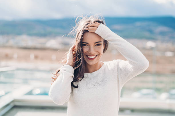 istock Beautiful young woman on a windy day 1192951202