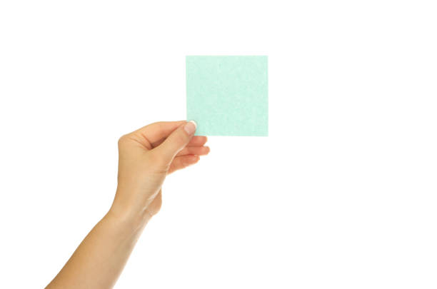 istock Woman hand holds virtual card or smart phone on white background 1192951380
