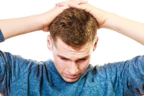 istock Closeup stressed man holds head with hands 1192952261