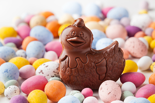 Easter concept: chocolate hen on colorful chocolate eggsEaster chocolate hen and bunnies on colorful chocolate eggs background