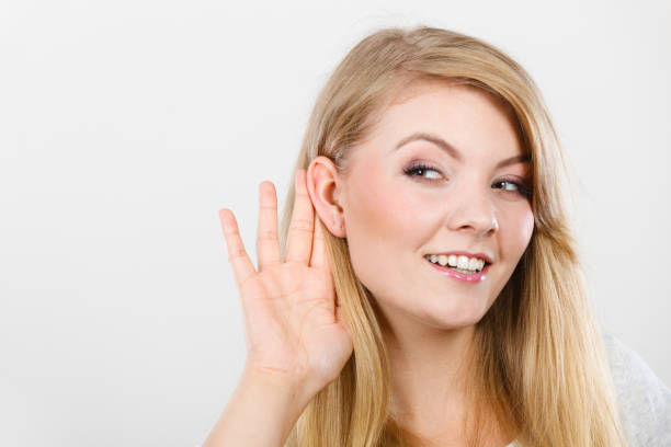 istock Woman putting hand ear to hear better 1192952377