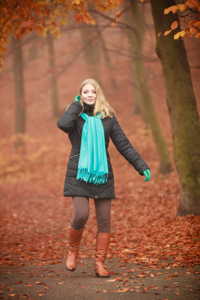 istock Girl is walking through the park. 1192954619