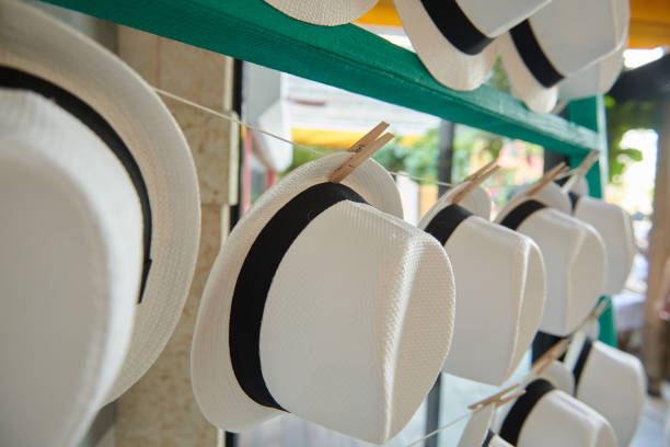 Hat rack display with rows of white straw woven hats stock photo