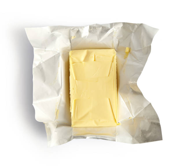 Piece of butter isolated on white background, top view