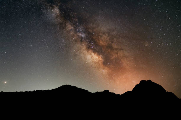 beautiful detailed long exposure night photo of milky way, galaxies and constellations above mountains - passion mountain range mountain national park imagens e fotografias de stock