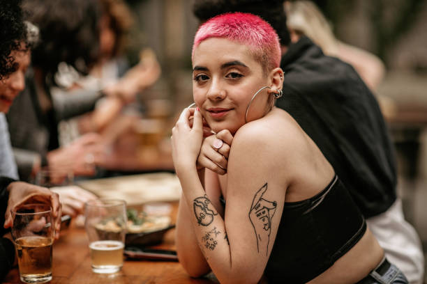 istock Hipster woman drinking beer at restaurant 1192963151