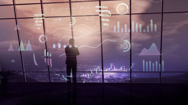 istock A businessman surrounded by infographics is standing against an office window. 1192967498