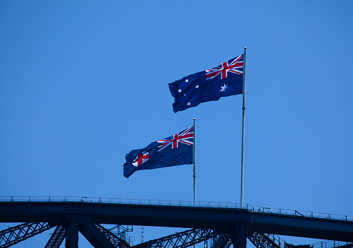 Two Australian flags flying on top of Sydney Harbor Bridge