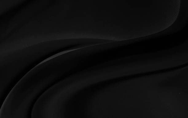istock Black gray satin dark fabric texture luxurious shiny that is abstract silk cloth background with patterns soft waves blur beautiful. 1192980045