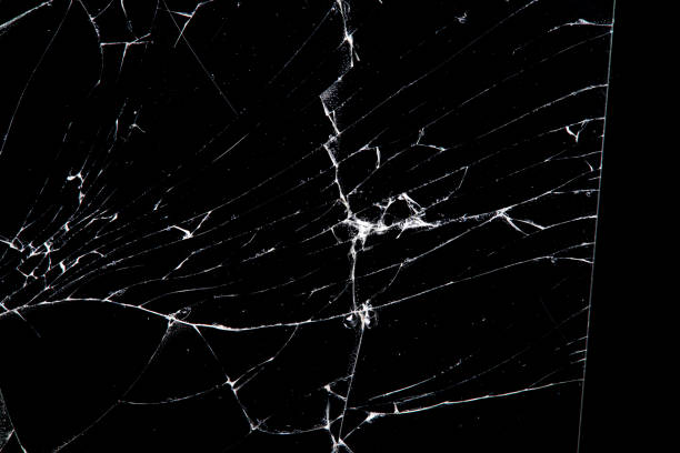 istock cracked glass isolated on a black background. 1192980410