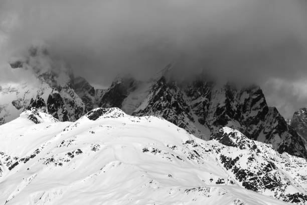 istock Snowy rocks in haze and storm clouds before blizzard 1192980648
