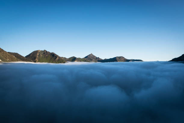Crisp, cold morning with beautiful cloud inversion, observed from Cabane de Moiry in Swiss Alps. stock photo