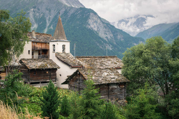 Small, white, old church in the village of La Sage in Swiss Alps. stock photo