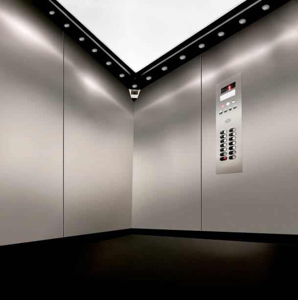 istock stainless steel inside of elevator lift with corner camera,  buttons and lights 1192994164