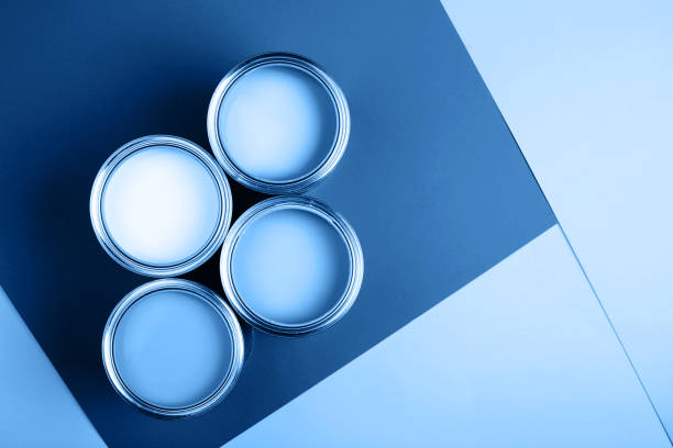 istock Four open cans of paint on bright background. 1192994538
