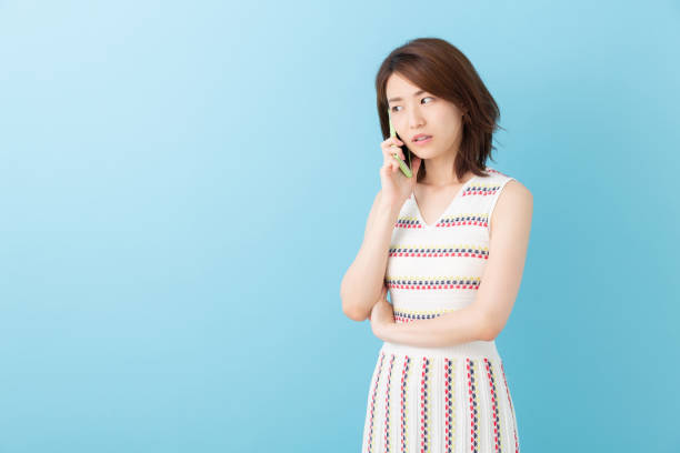 istock asian woman who talks on the telephone,think, 1192995409