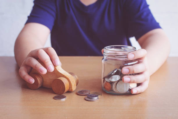 boy saving money for buying car. plan for buying car concept. - coin cheap jar currency imagens e fotografias de stock