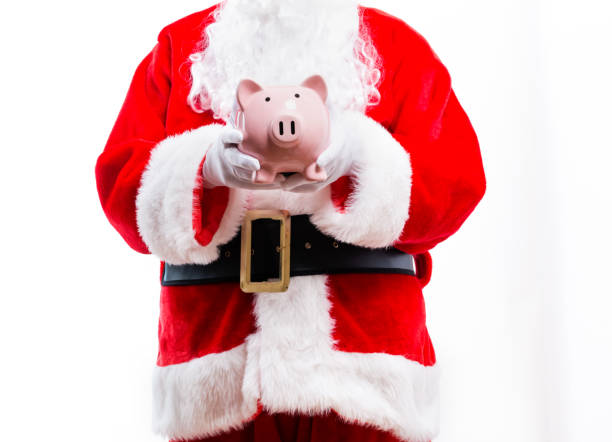 istock Santa holding a piggy bank 1192999389