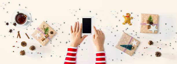 istock Christmas ornaments with person using a smartphone 1192999613