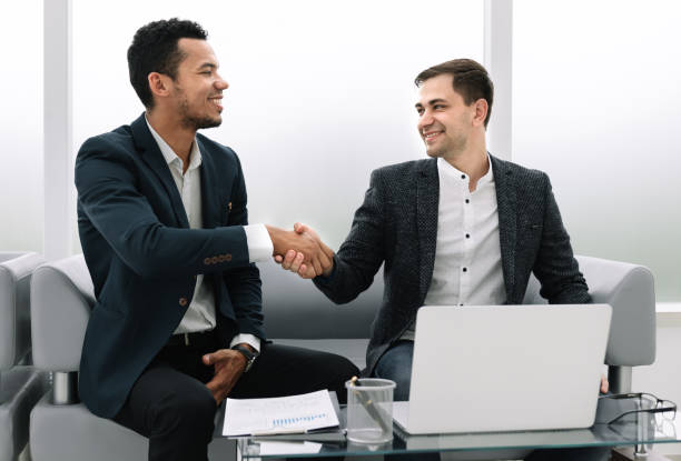 istock business partners shaking hands after discussing the contract. 1193003972