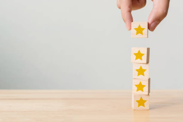 istock Hand building wood block cube stacking on top with five star shape. The best excellent business services rating customer experience concept 1193012833