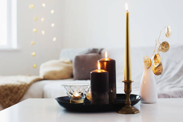 istock black and golden candles on white table 1193012855