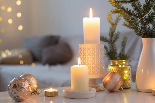 istock Christmas decorations with burning candles in white interior 1193012874